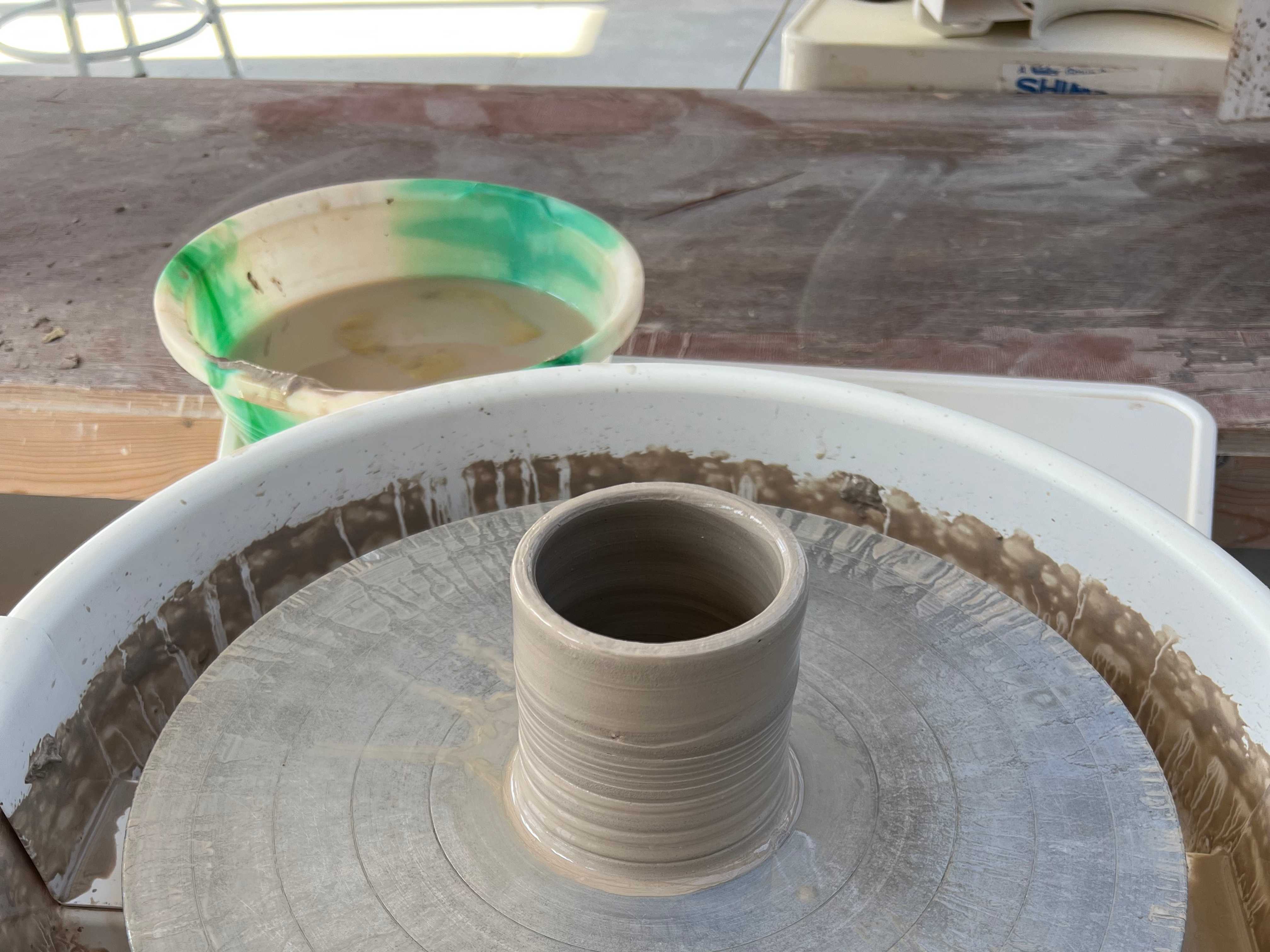 A pottery cylinder on the wheel